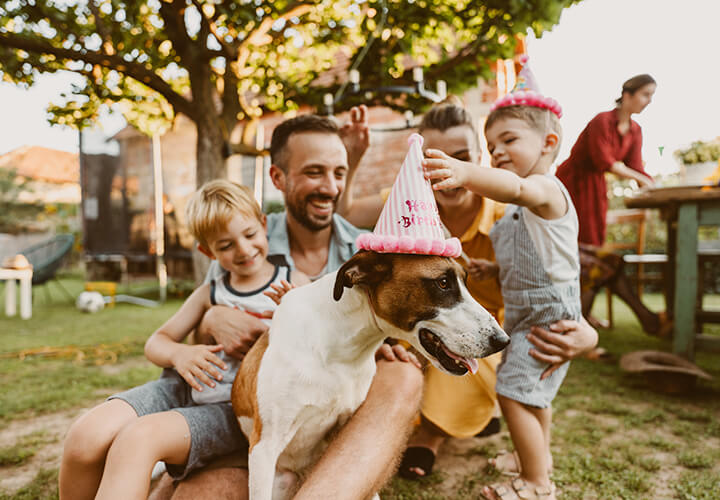 Group of people at birthday party with dog