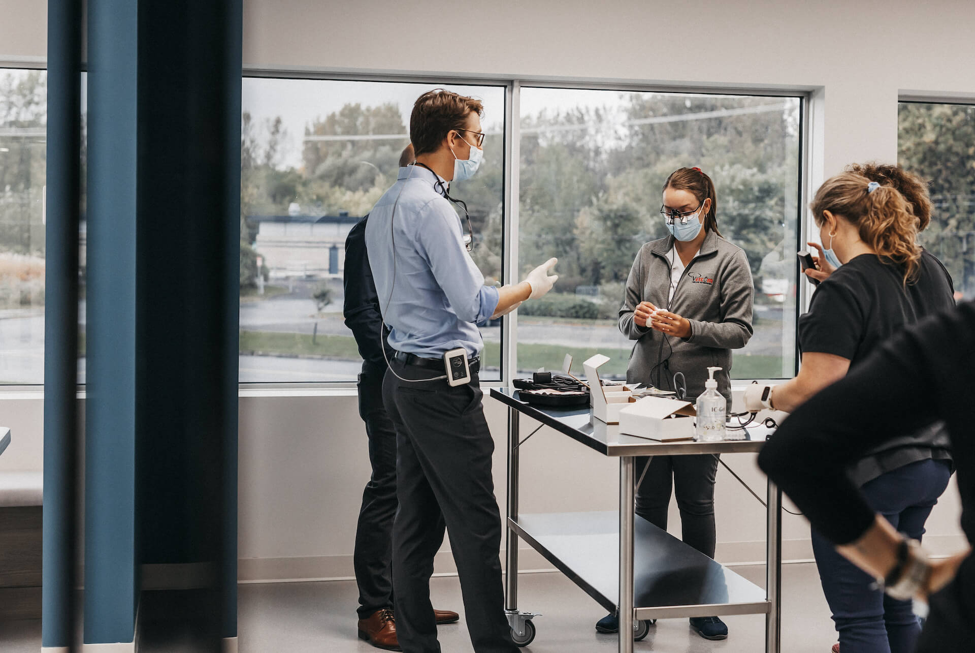 Group of veterinarians around table of equipment