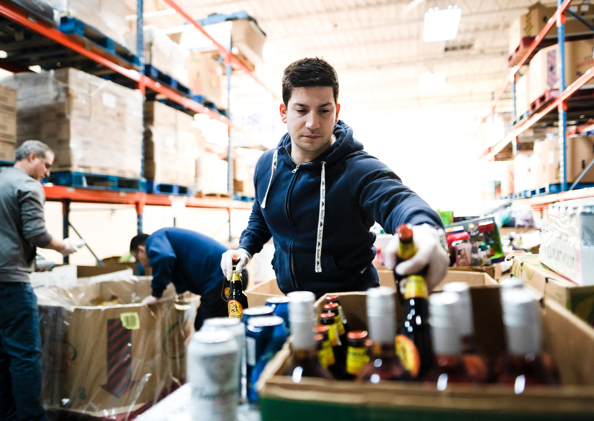 Man putting bottles into box